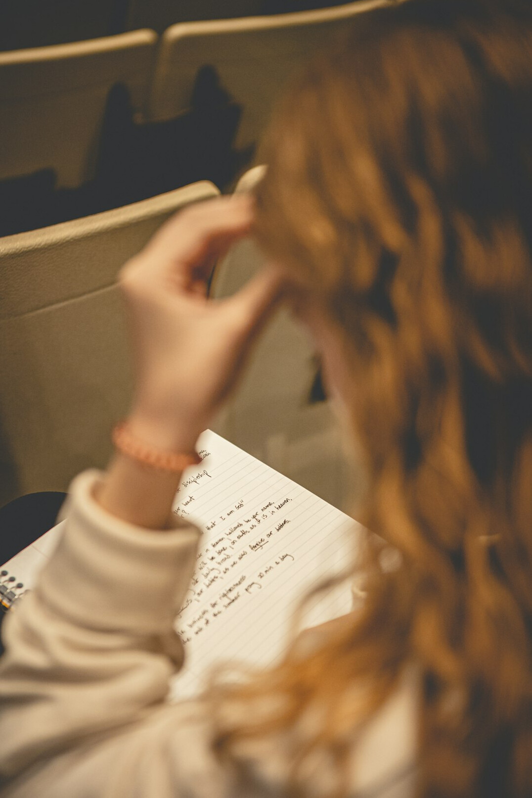 person writing notes in notebook