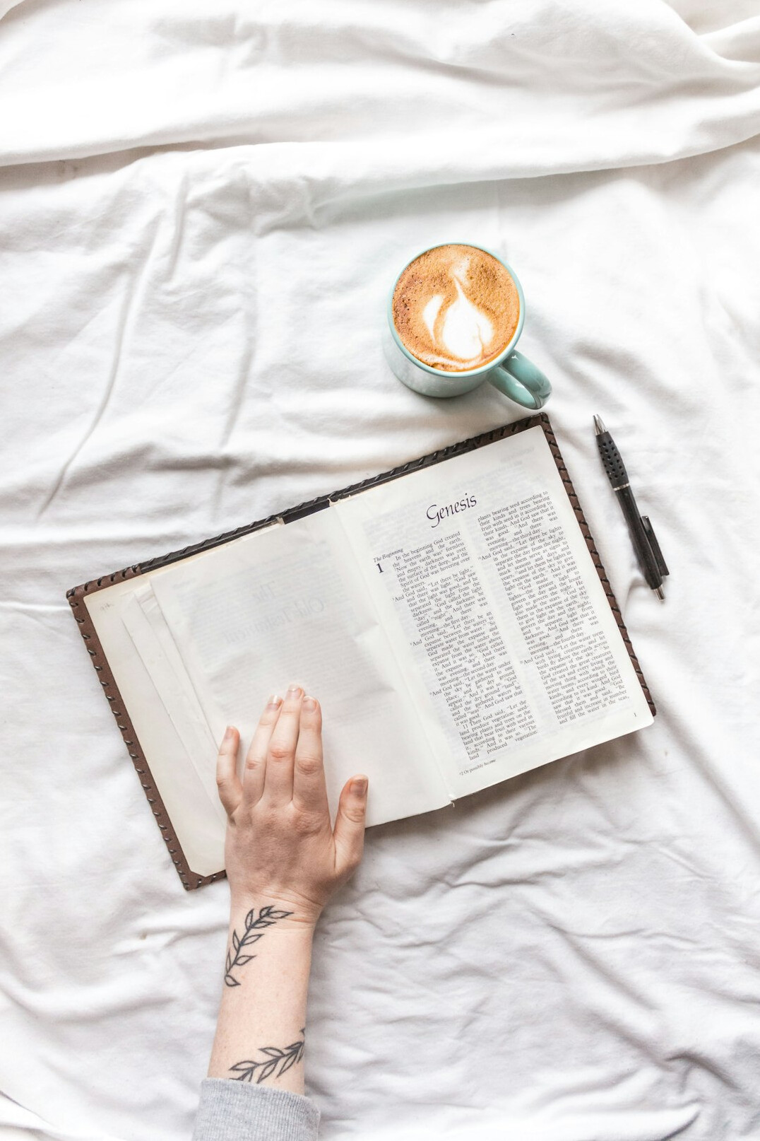 Hand writing in a notebook with a pen