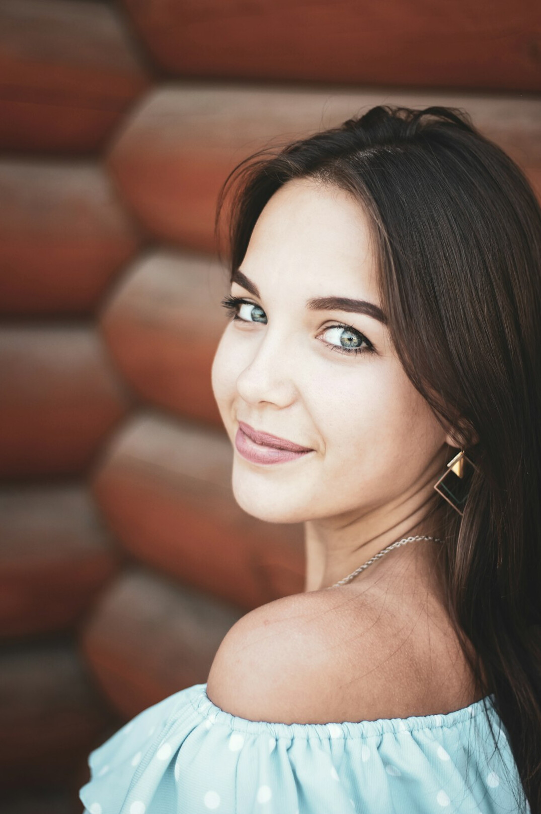 Portrait of a young smiling woman with dark hair