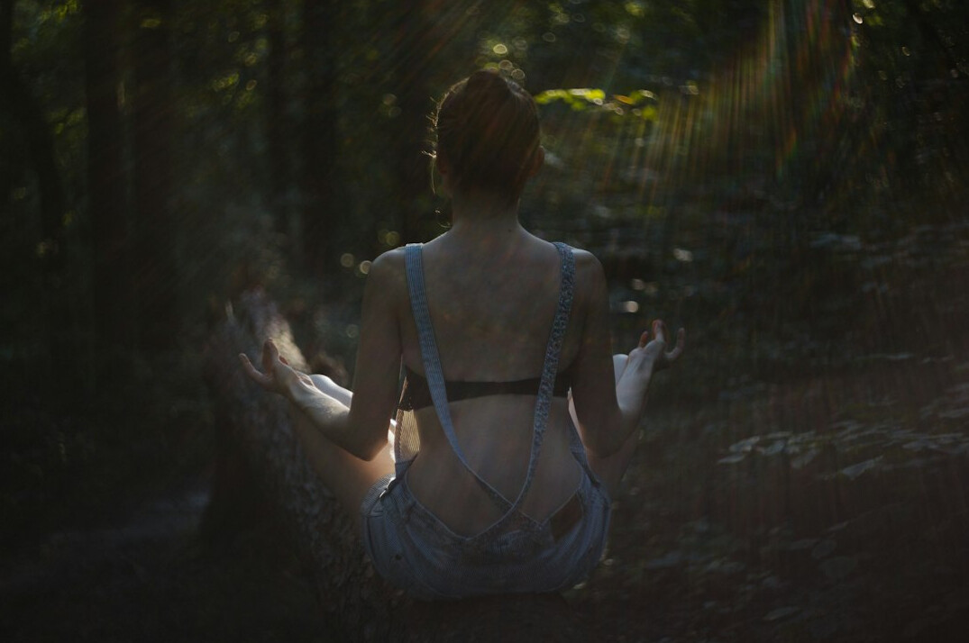 person meditating outdoors